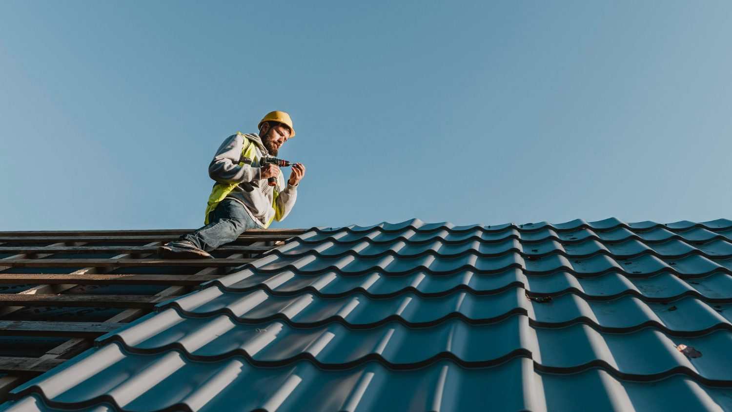 roof repair long-shot-man-working-roof top